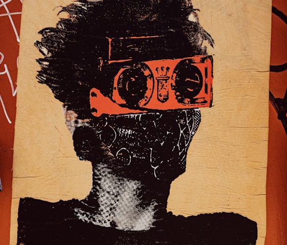 A stylized piece of street art depicts a person with wild hair. The character wears bright orange goggles and a patterned mask, giving a futuristic or rebellious vibe. The background is a textured brown surface with graffiti and the word 'SPORT' partially visible in bold letters.